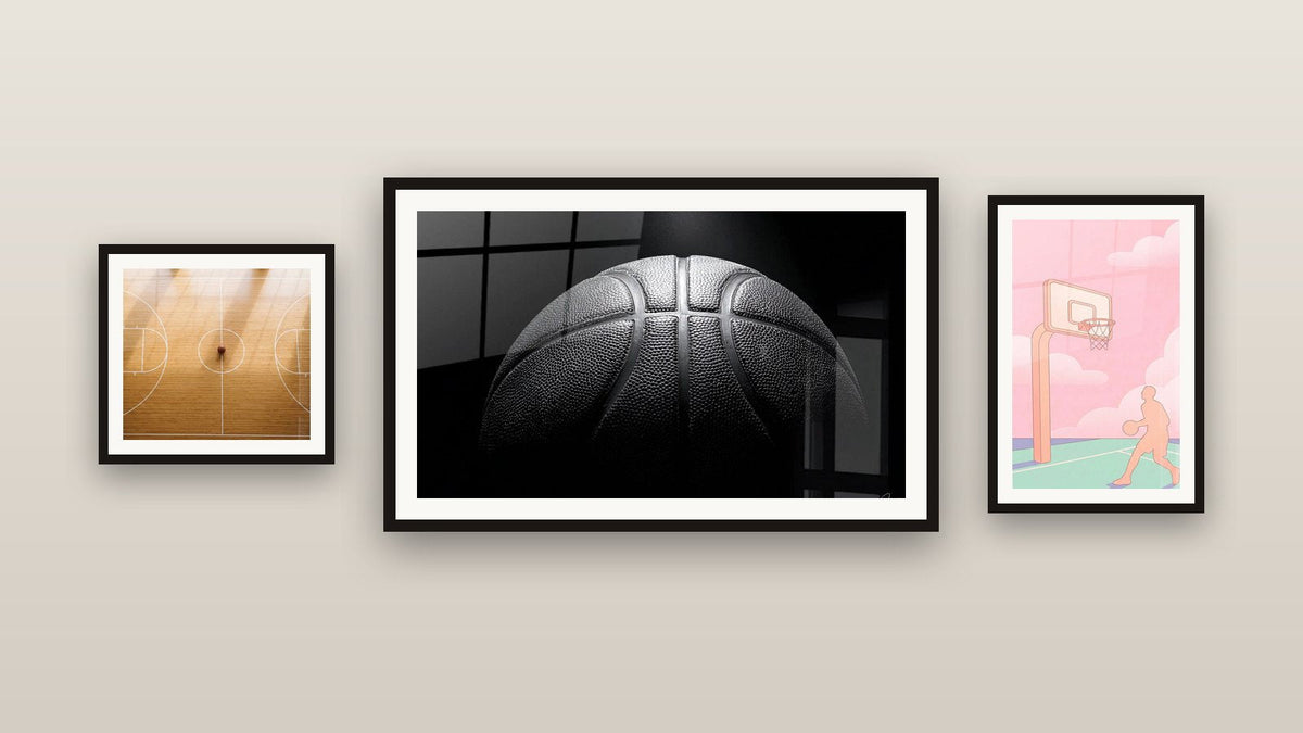 Gallery wall with three framed paintings: Basketball, Basketball Court Aerial View and Pink Basketball Court