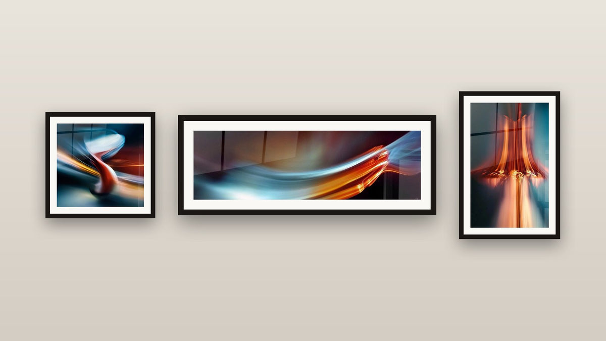 Gallery wall with three framed paintings: Abstract Light Flow, Light Cascade and Modern Chair