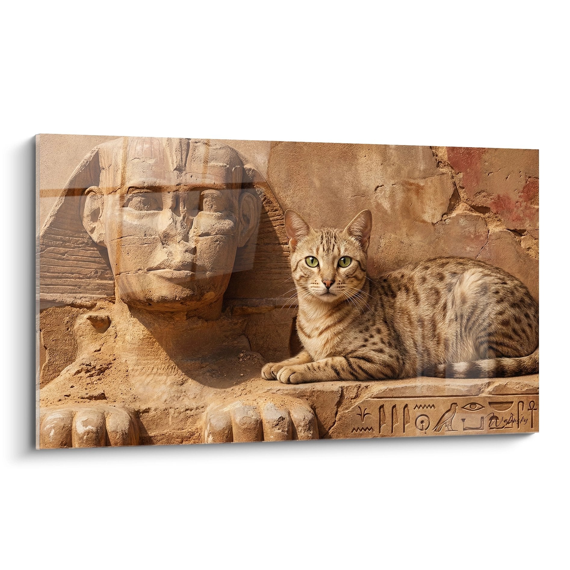 Egyptian Mau cat sitting near an ancient Egyptian sphinx with hieroglyphics carved in golden stone