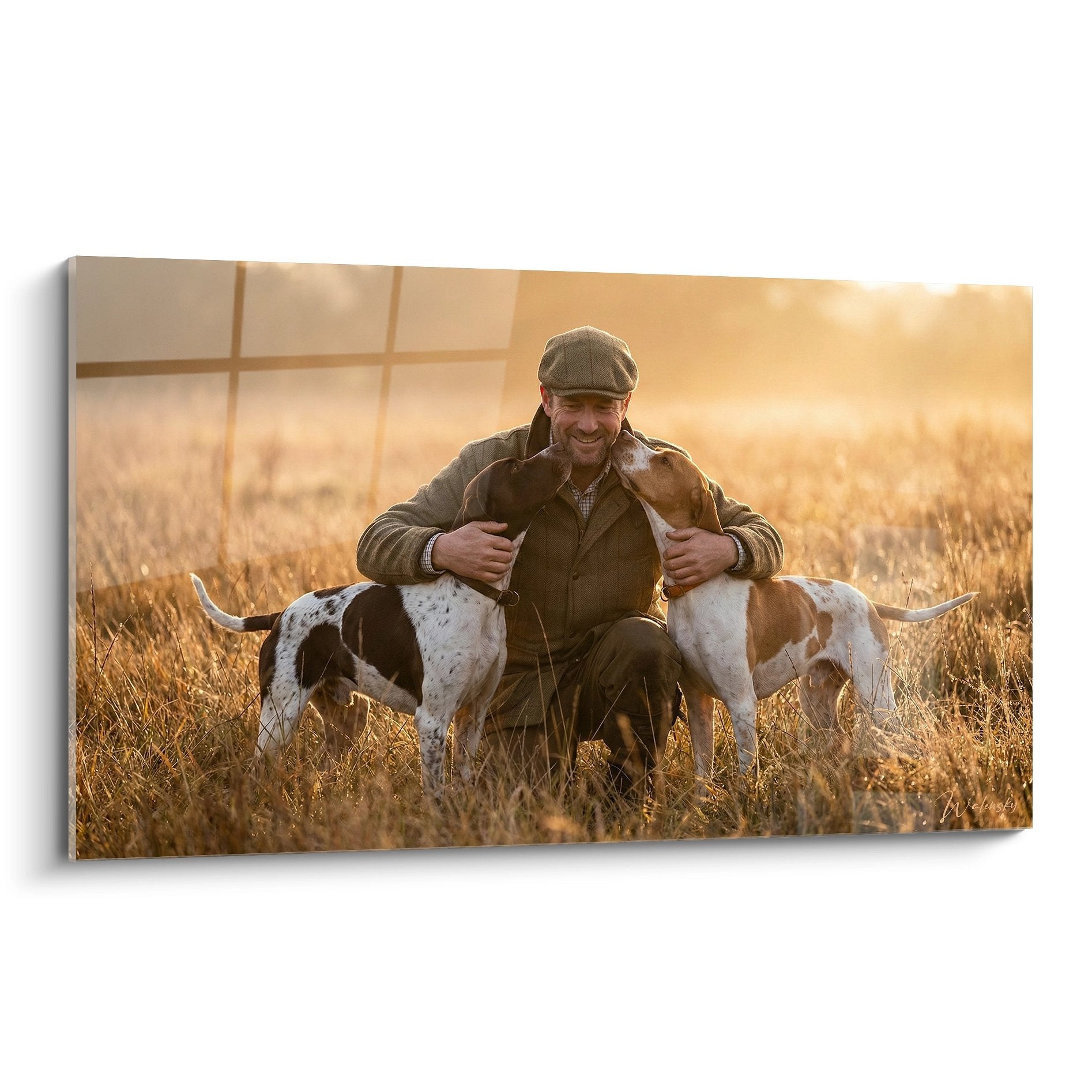 Tableau représentant un chasseur en tenue traditionnelle avec ses deux chiens de chasse au coucher du soleil