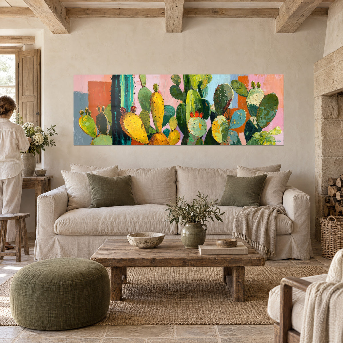 Tableau cactus raquettes jaune soleil et vert sauge sur fond rose, signé Walensky, au-dessus d'un canapé dans un salon lumineux