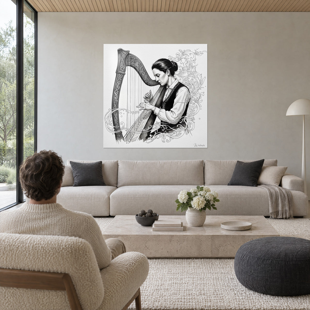 Wall art of a harpist with closed eyes lightly touching the strings, black ink and ivory white, above a sofa in a bright living room