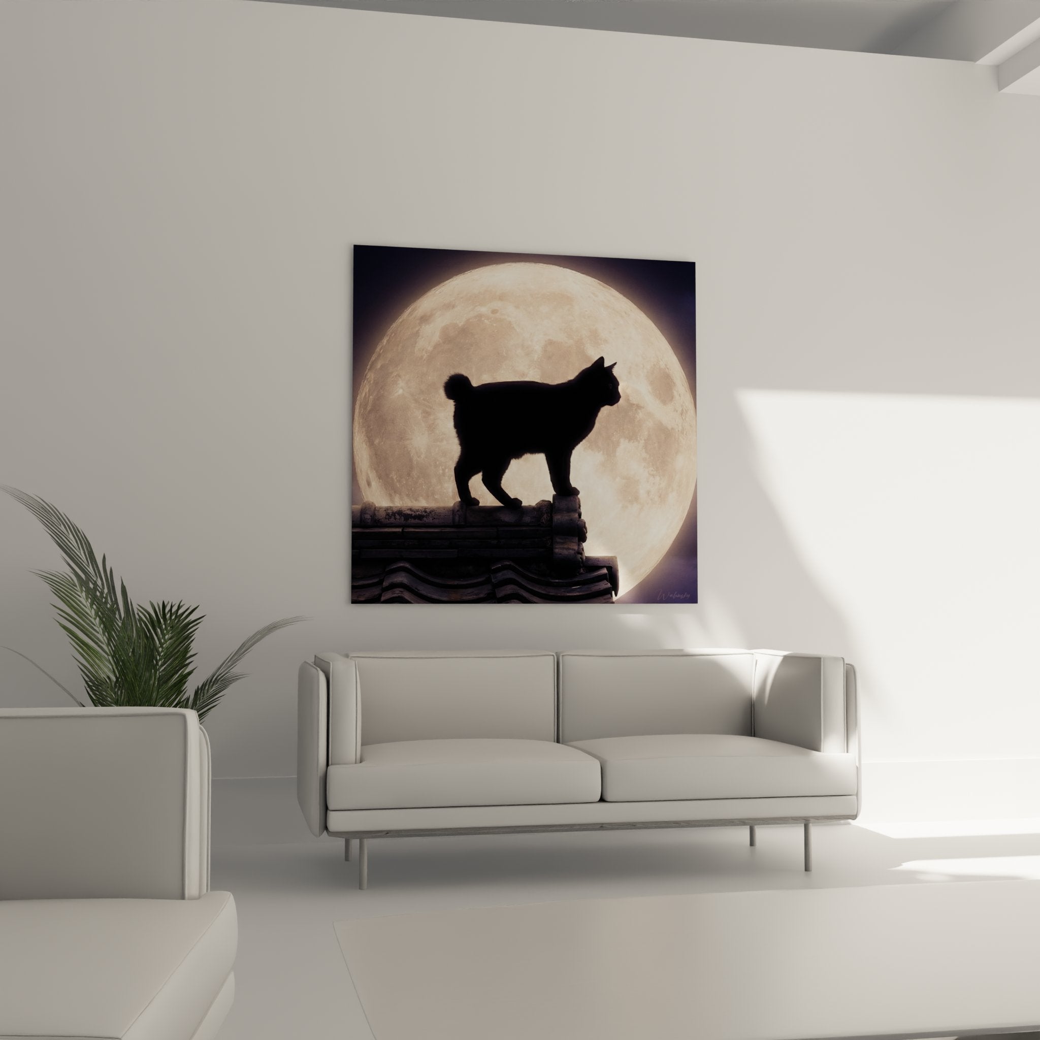 Black silhouette detail of Japanese Bobtail cat with short tail against large glowing golden moon