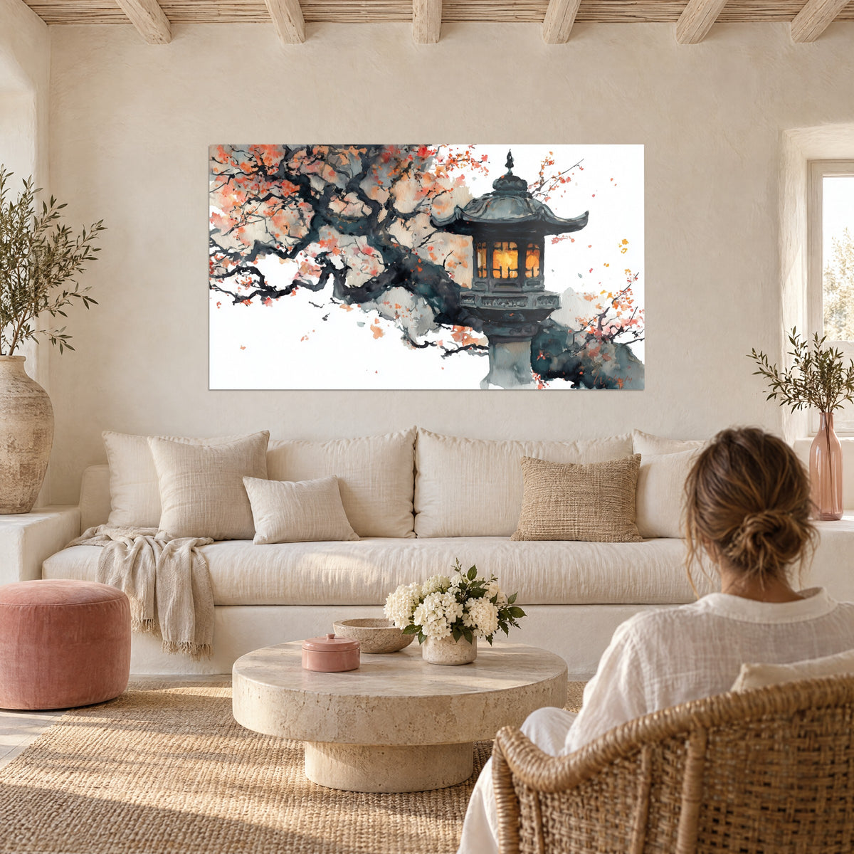 Cuadro linterna de piedra oscura con ventanas ámbar bajo un cerezo coral y gris, sobre un sofá en un salón luminoso
