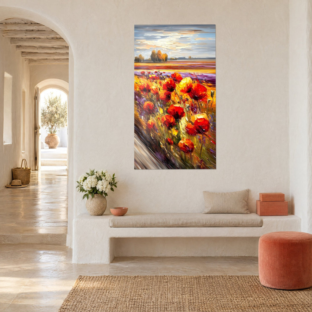 Wall art flowering field with orange and red petals under a cloudy blue sky, hung on the white wall of a Mediterranean vaulted hallway