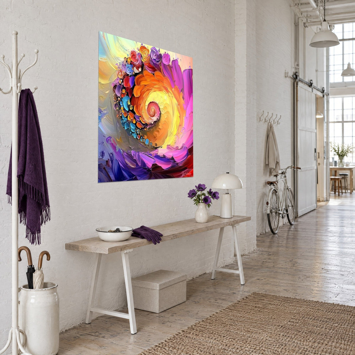 Wall art spiral of palette-knife painted roses, vivid orange and deep purple, angled view beside a light wood console