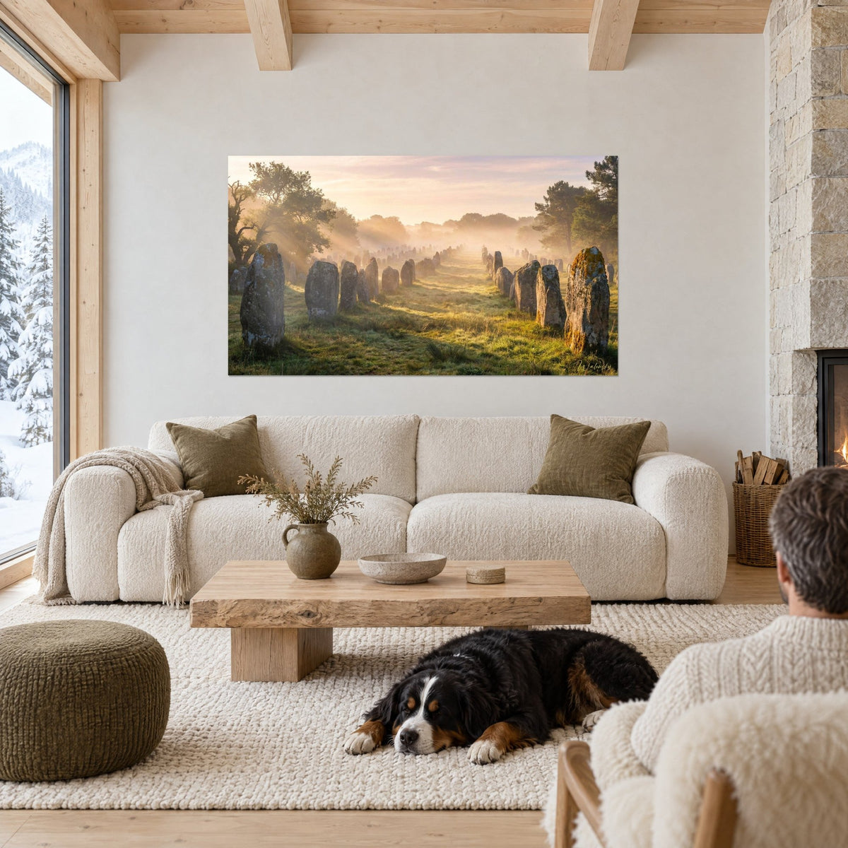 Wall art aligned standing stones in golden mist, ochre moss and green grass, above a sofa in a bright living room