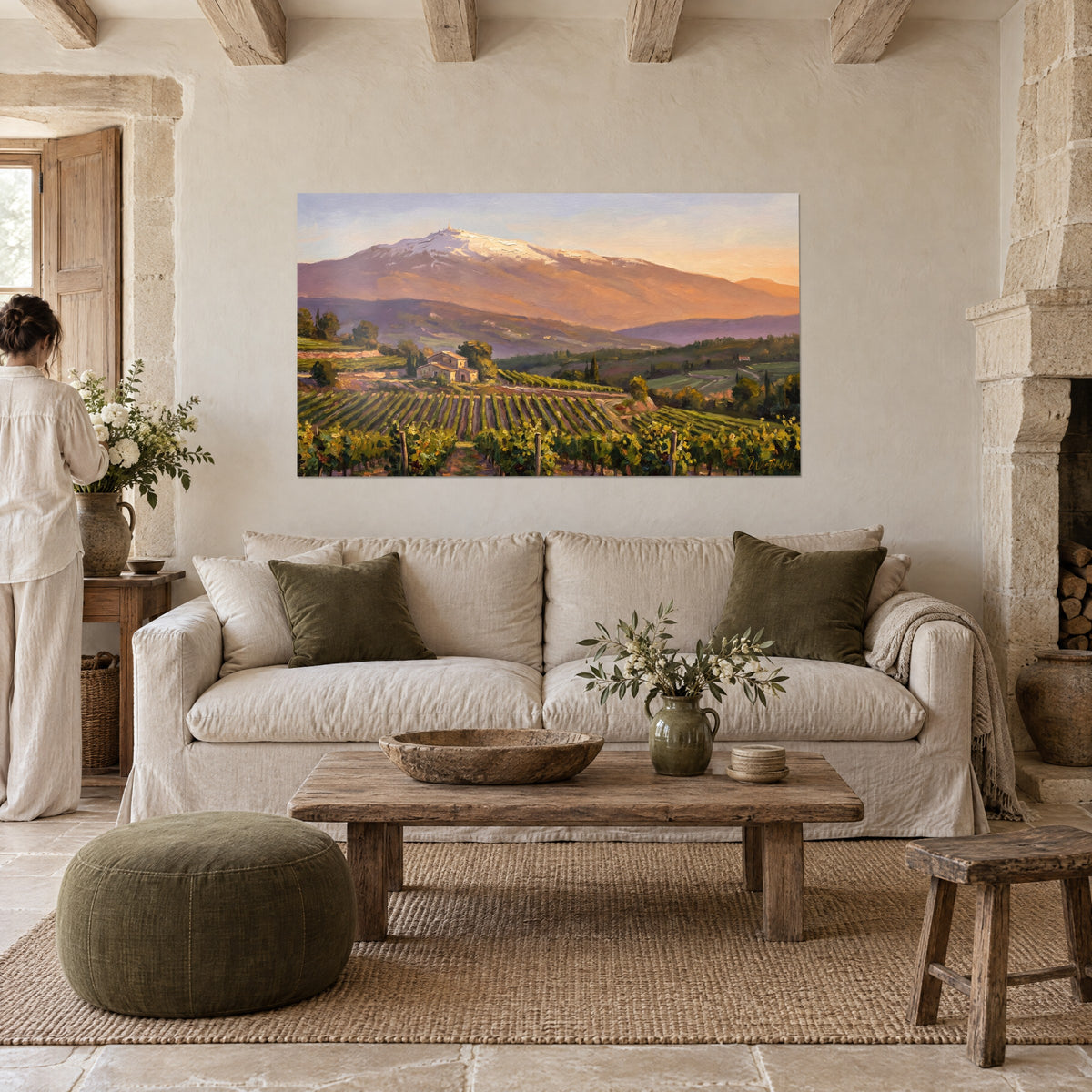 Wall art snow-capped Mont Ventoux blushed by sunset, olive green vineyard rows, above a sofa in a bright living room