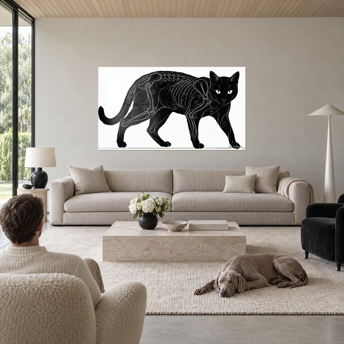 Cuadro gato negro con esqueleto dibujado en volutas blancas, fondo marfil, pareja de espaldas y weimaraner gris sobre un sofá en un salón luminoso