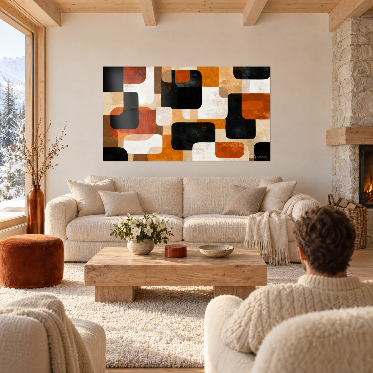 Tableau mosaïque de rectangles arrondis noirs, orange brûlé et crème, deux personnes de dos, au-dessus d'un canapé dans un salon lumineux