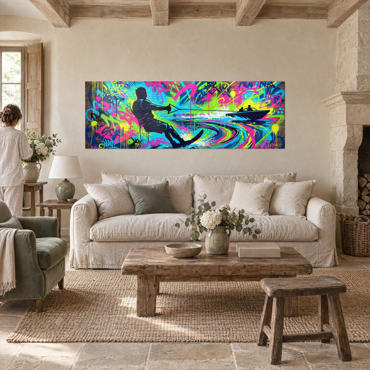 Tableau skieur nautique en silhouette marine tirant sa corde, fond graffiti rose et cyan, au-dessus d'un canapé dans un salon lumineux