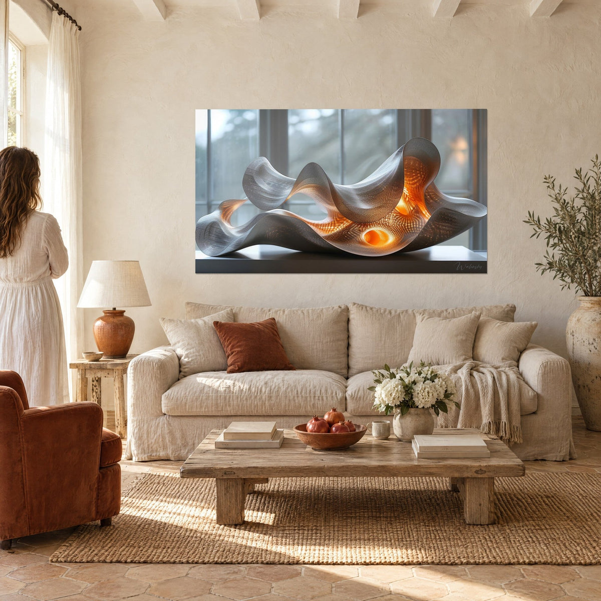 Wall art of a wavy silver sculpture lit in orange, two people seen from behind, above a sofa in a bright living room