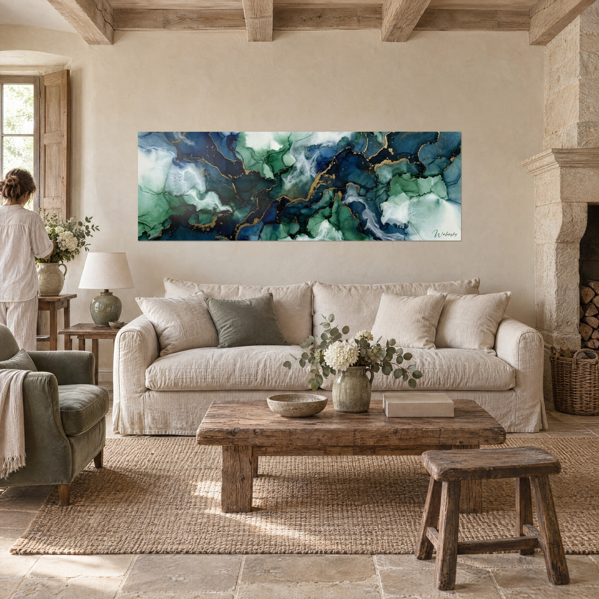 Wall art with marbled ink in navy blue and emerald green, veined with gold, hung above a sofa in a bright living room