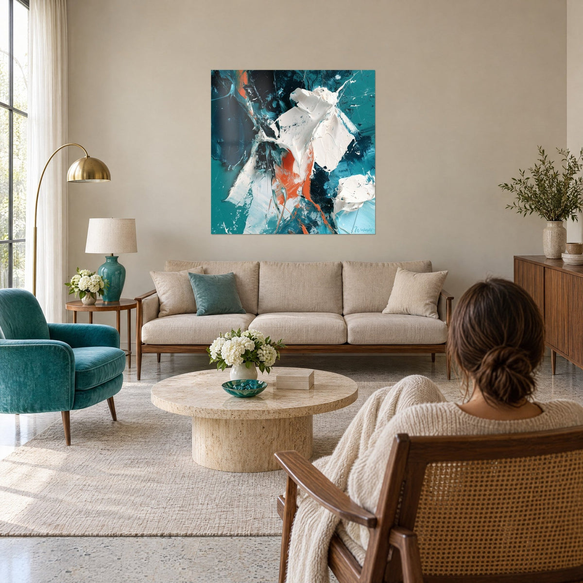 Wall art with white raised paint streaks on a teal and midnight blue background, orange accents, above a sofa in a bright living room