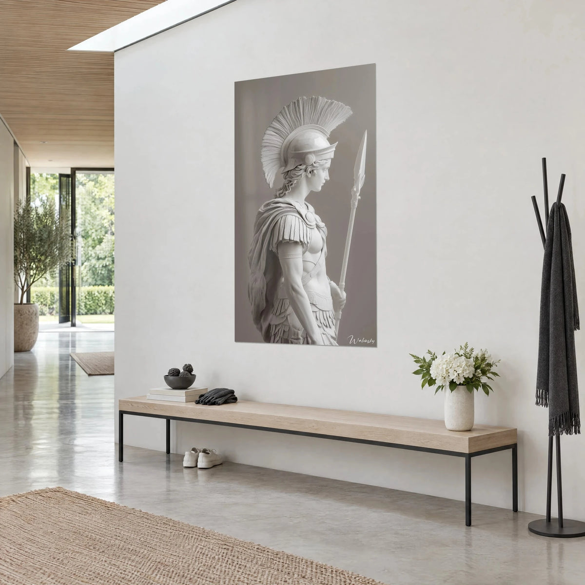 Wall art of Athena in white marble, striped crest and draped cloak on grey-taupe background, on a white wall in the glazed entrance