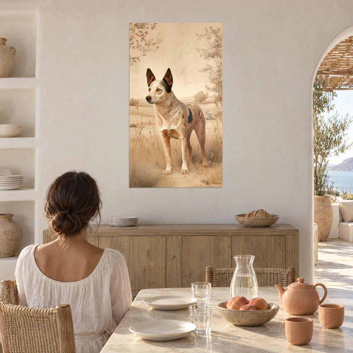 Wall art of an Australian Cattle Dog with amber eyes, white coat flecked with auburn, golden field, beside a white arch and a wooden table