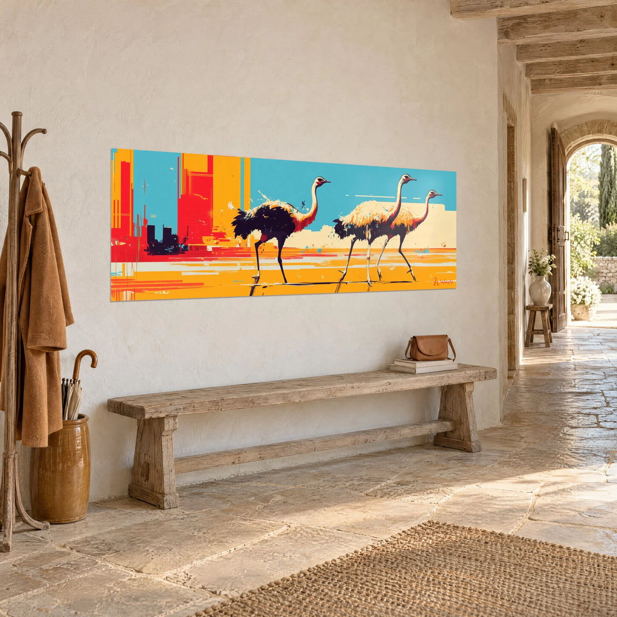 Wall art running birds with pink necks on saffron yellow ground, turquoise background behind them, hung above an antique stone bench