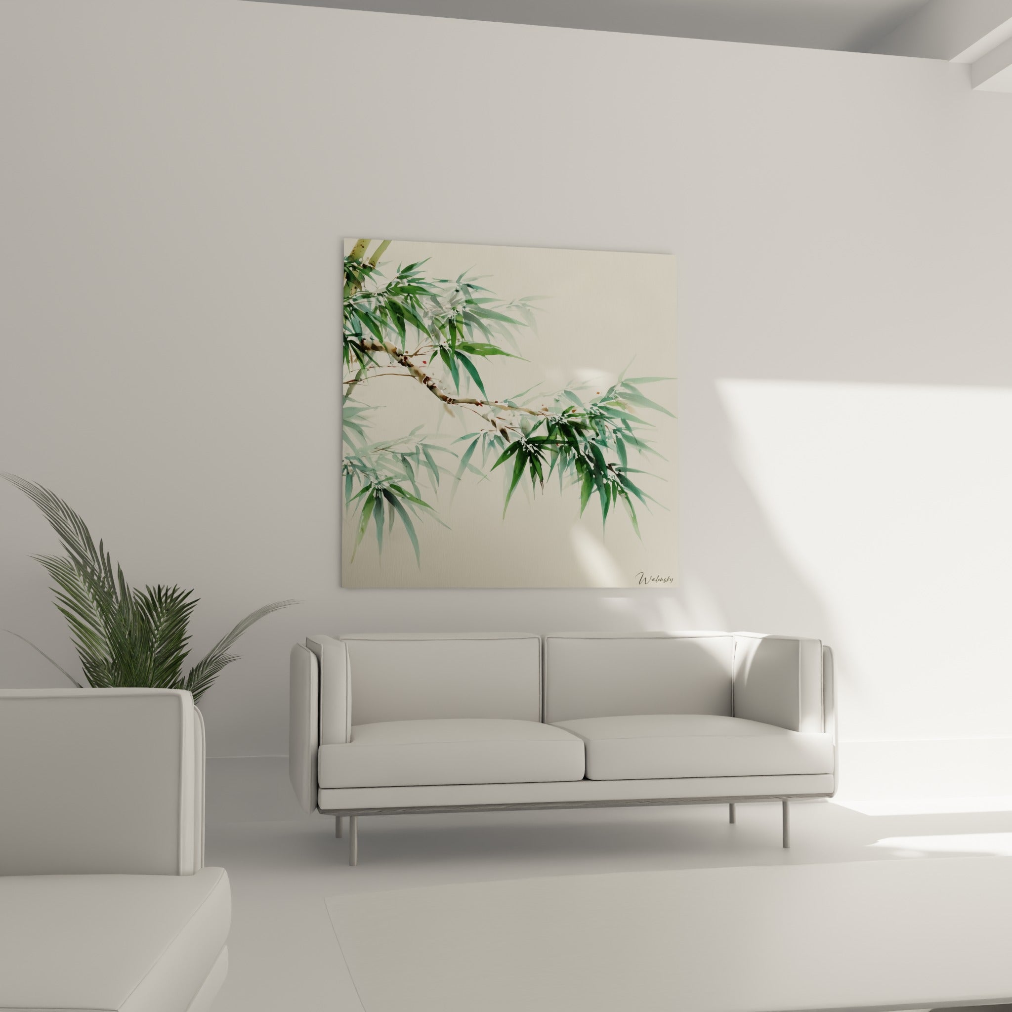 Tige de bambou brune ornée de feuilles vertes et touches rouges, au-dessus d'un canapé dans un salon lumineux