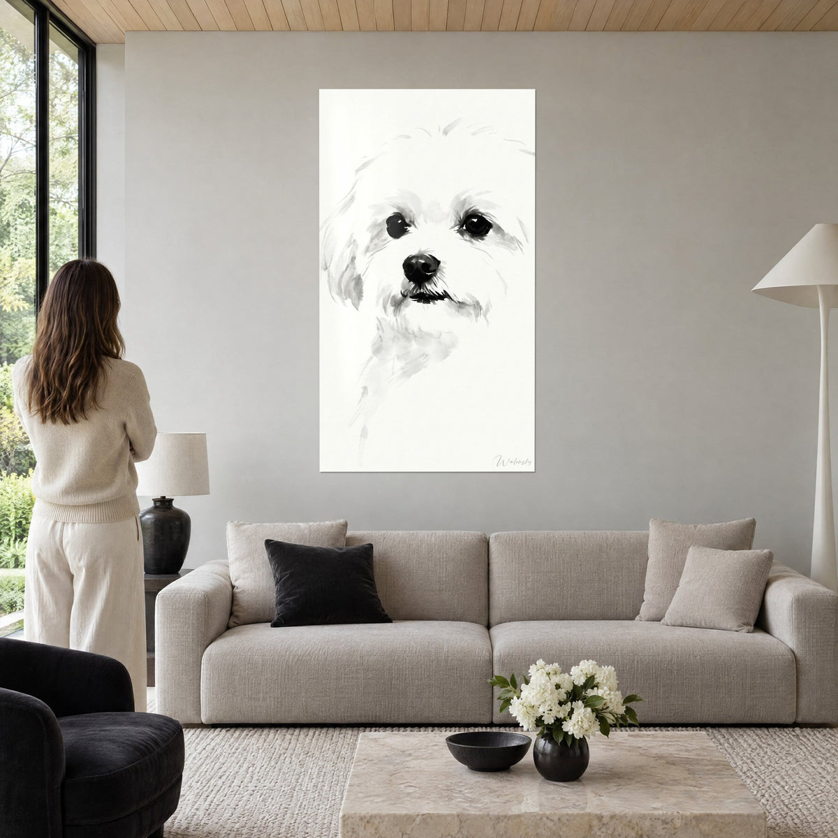 Wall art Maltese puppy with large black eyes, white coat and grey ink wash, woman seen from behind, above a sofa in a bright living room
