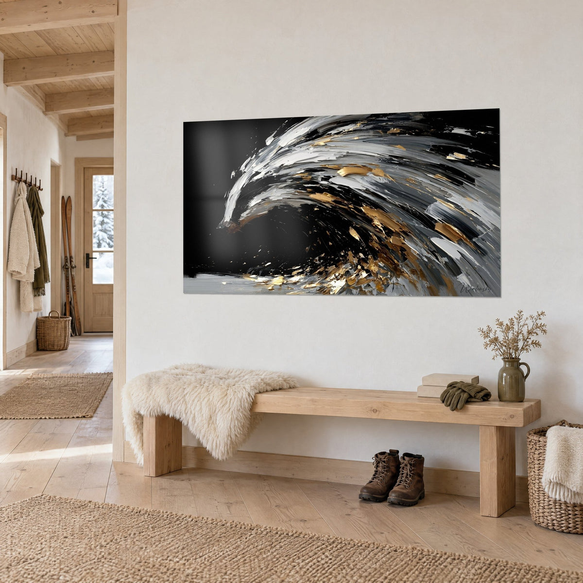 Wall art black wave fringed with silver foam and gold glitter, hung near a light wooden bench in a chalet entrance
