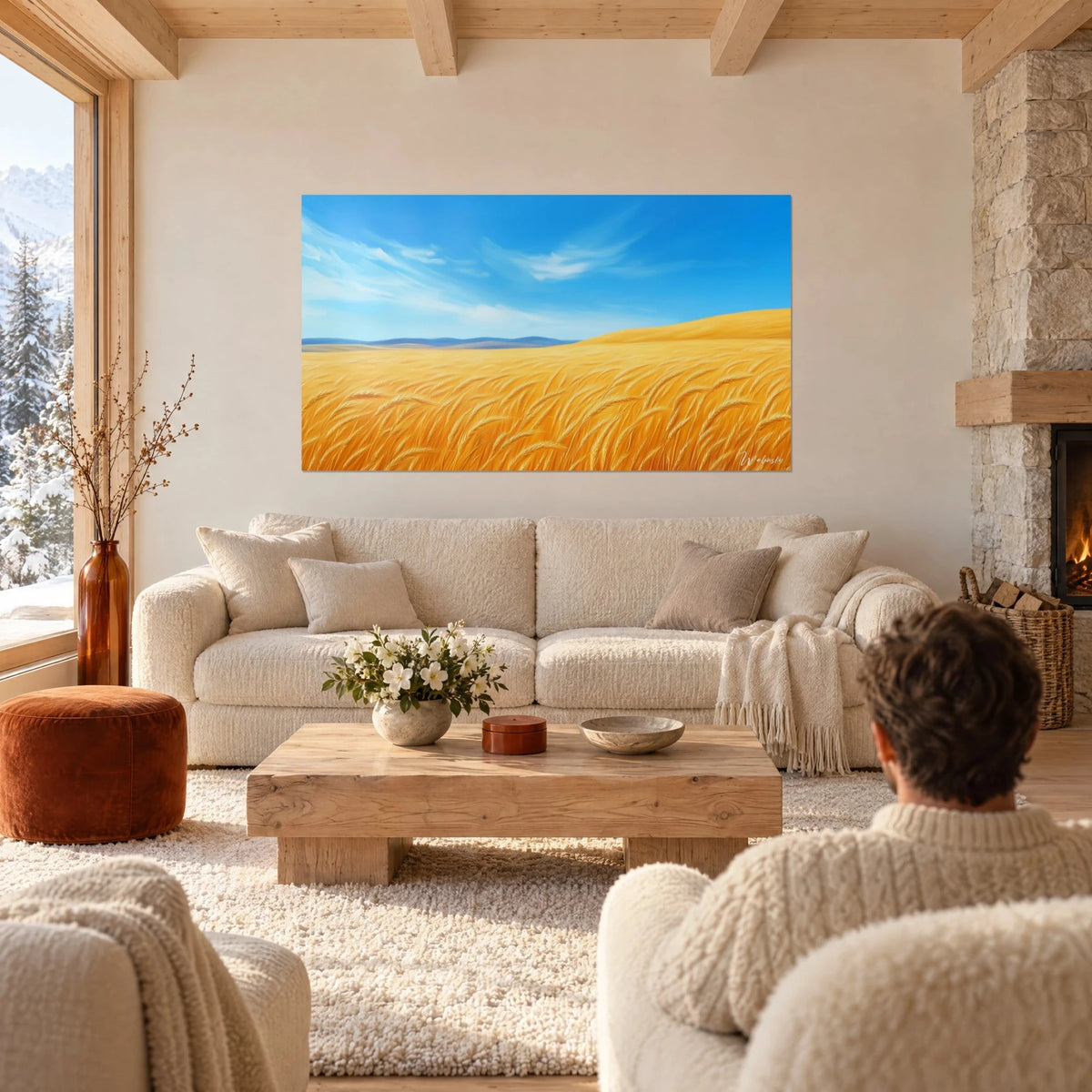 Wall art golden wheat field under a azure sky streaked with clouds, hung above a sofa in a bright living room