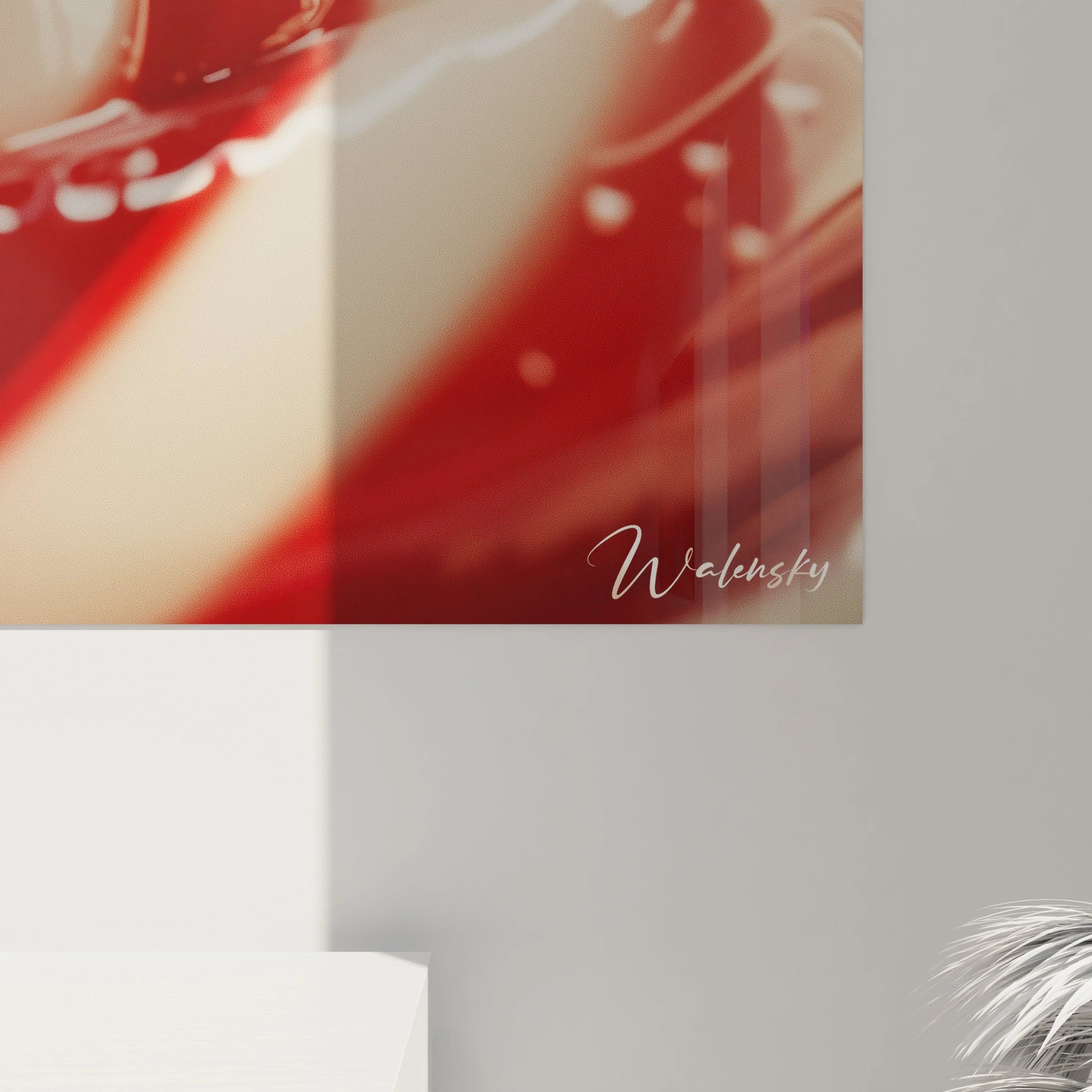 Un tableau bonbon mettant en avant des courbes lisses rouges et blanches, avec un effet de brillance et des reflets donnant une impression de volume et de mouvement.