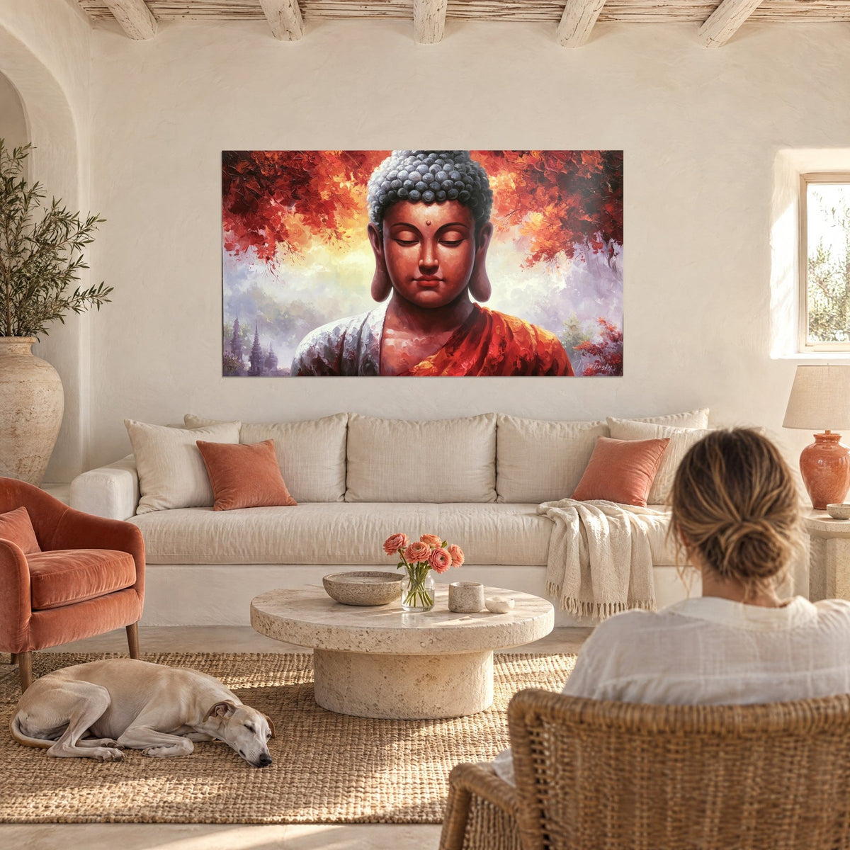 Tableau Bouddha aux paupières closes, feuillage écarlate et ciel ambré, vu par une femme de dos, au-dessus d'un canapé dans un salon lumineux