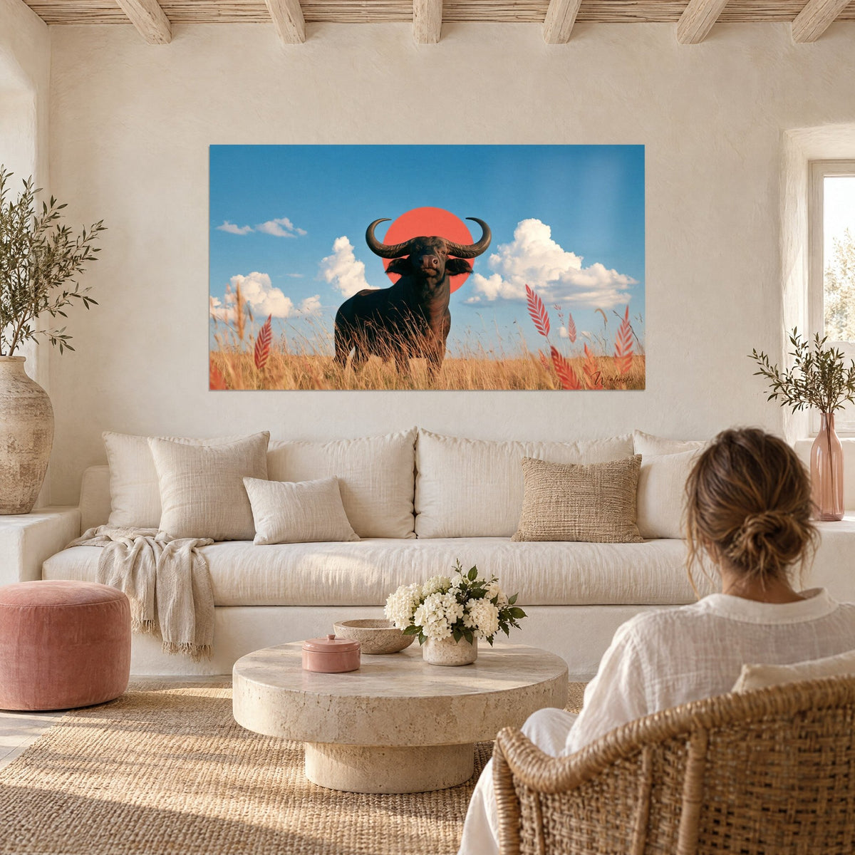 Quadro Bufalo nero con corna a mezzaluna, sole corallo e cielo azzurro, sopra un divano in un soggiorno luminoso