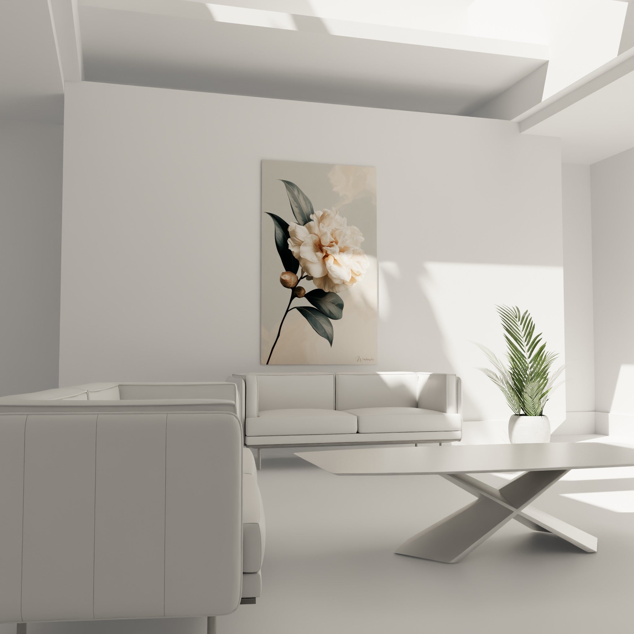 Pétales de camélia crémeux et feuilles anthracite au-dessus d'un canapé dans un salon lumineux