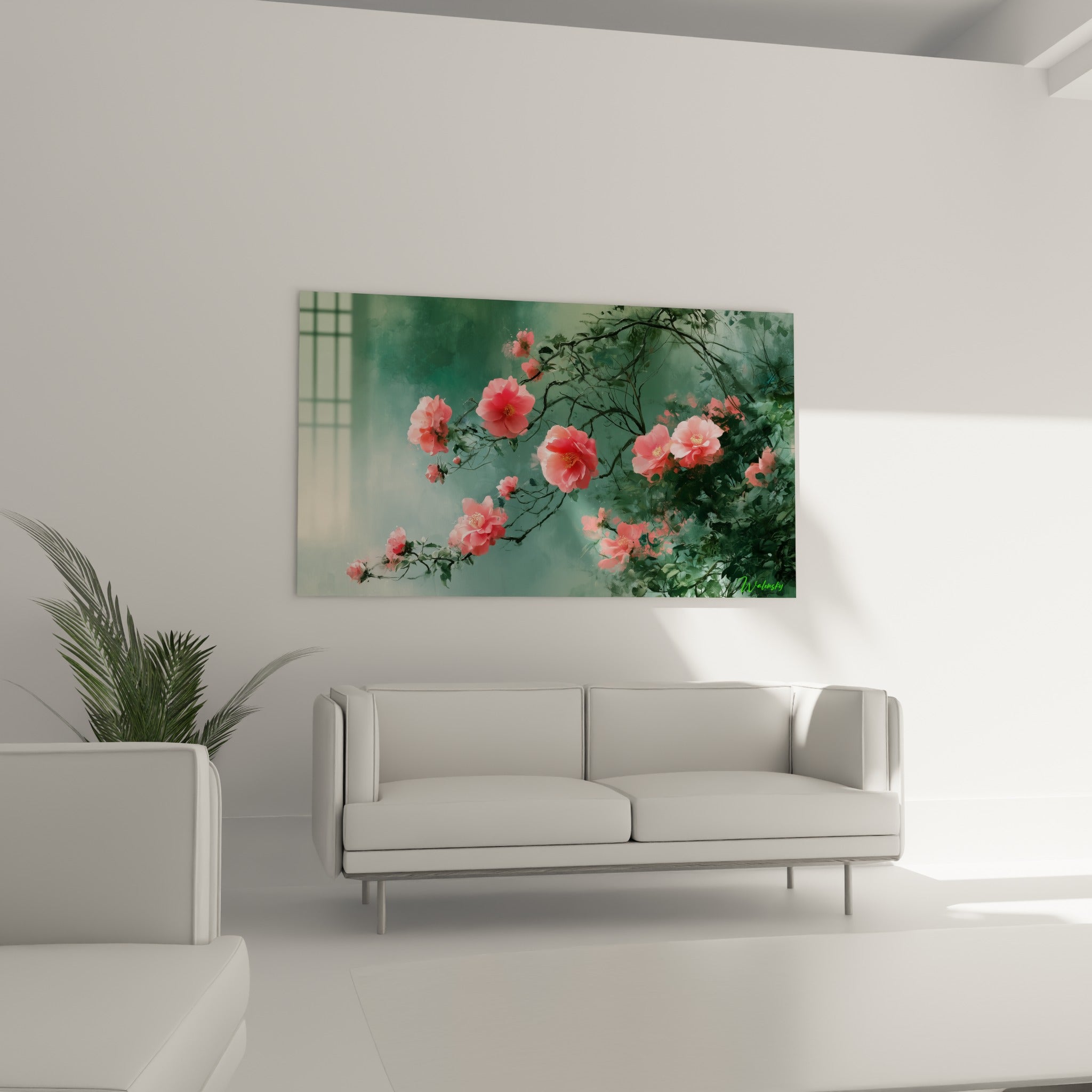 Branche fleurie de camélia rose et sauge disposée au-dessus d'un canapé dans un salon lumineux