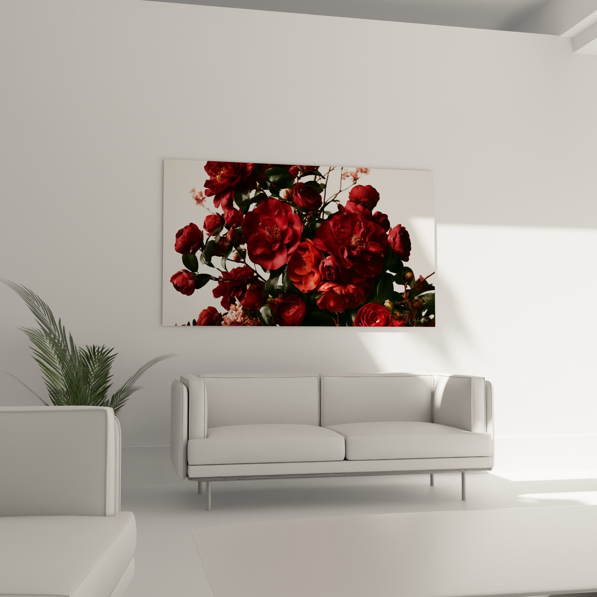 Fleurs de camélia rose corail et feuillage sombre disposées au-dessus d'un canapé dans un salon lumineux