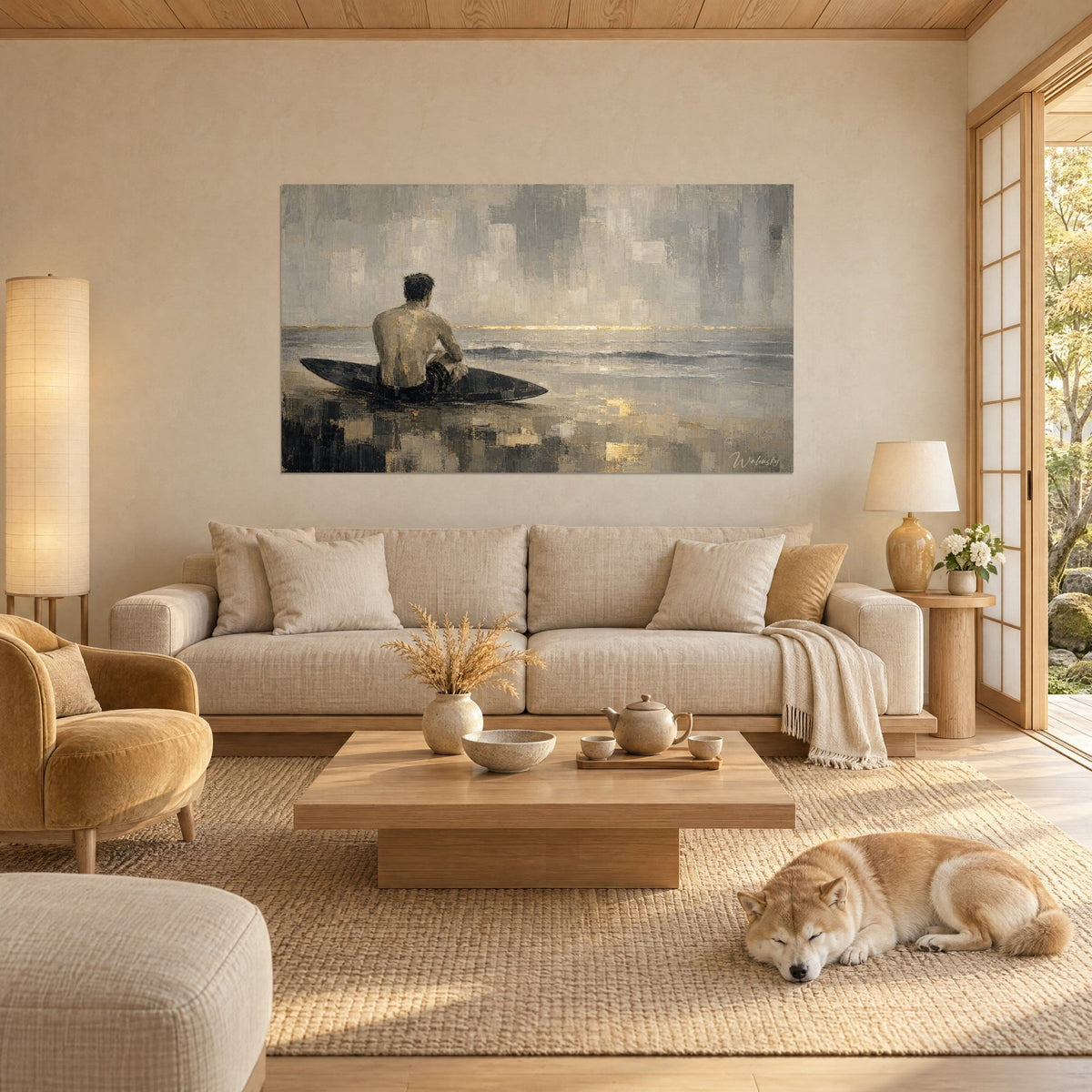 Wall art shirtless surfer sitting on his grey board, golden horizon over taupe ocean, sleeping Shiba, above a sofa in a bright living room
