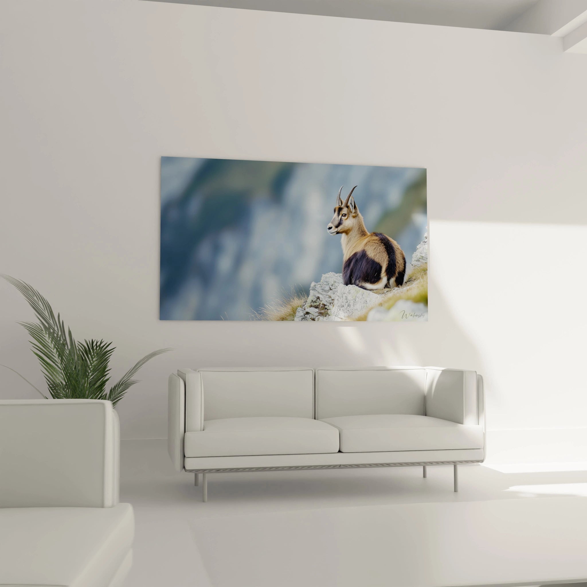 Un tableau artistique abstrait représentant un chamois vigilant aux cornes pointues sur un promontoire rocheux. Les teintes beiges et marron du pelage contrastent avec le gris des rochers et le bleu brumeux du paysage montagneux en arrière-plan.