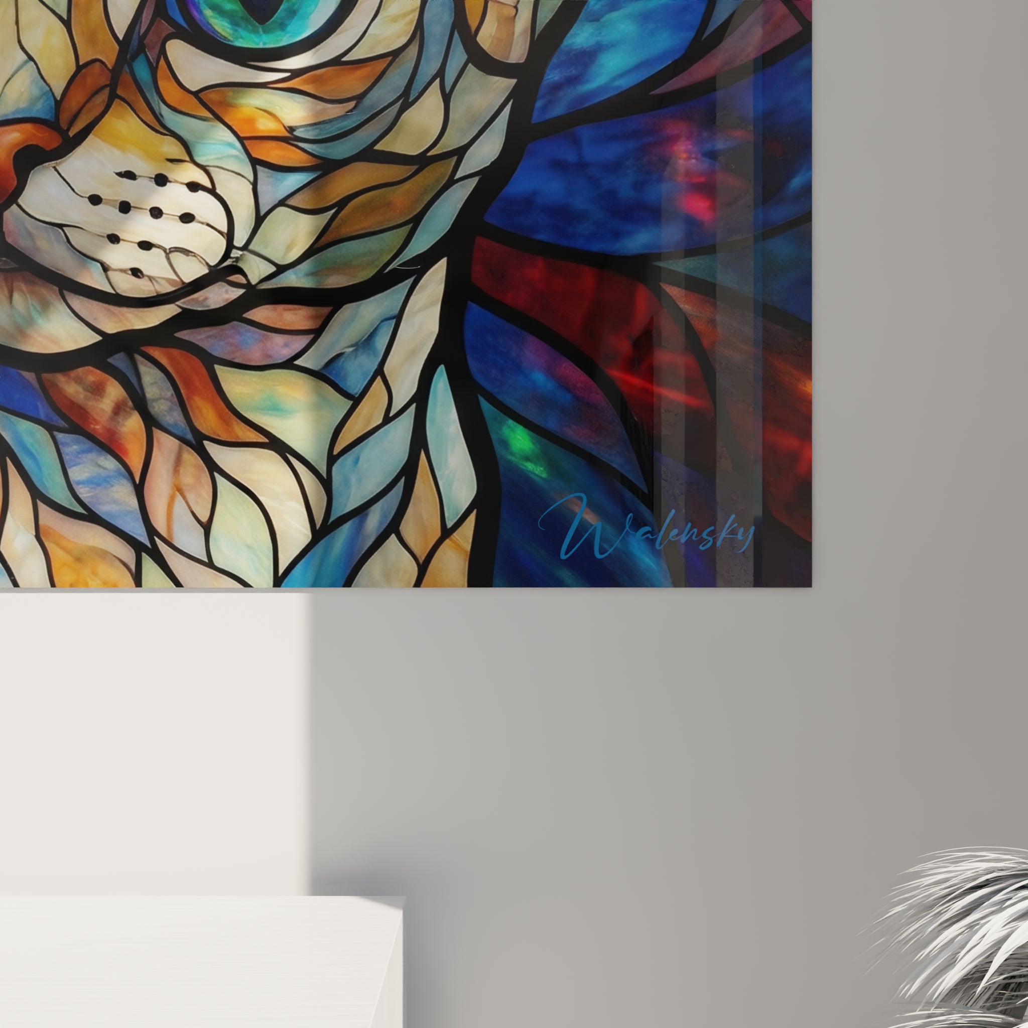 Facettes graphiques cernées de noir en orangé, turquoise et bleu marine visibles de près sur la toile.