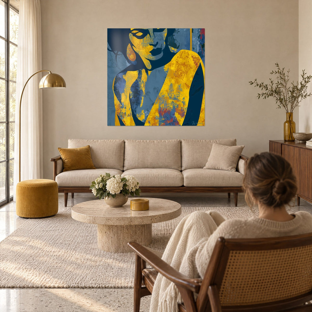 Tableau silhouette féminine stylisée, peau d'ocre doré et cheveux bleu nuit, une femme de dos au-dessus d'un canapé dans un salon lumineux