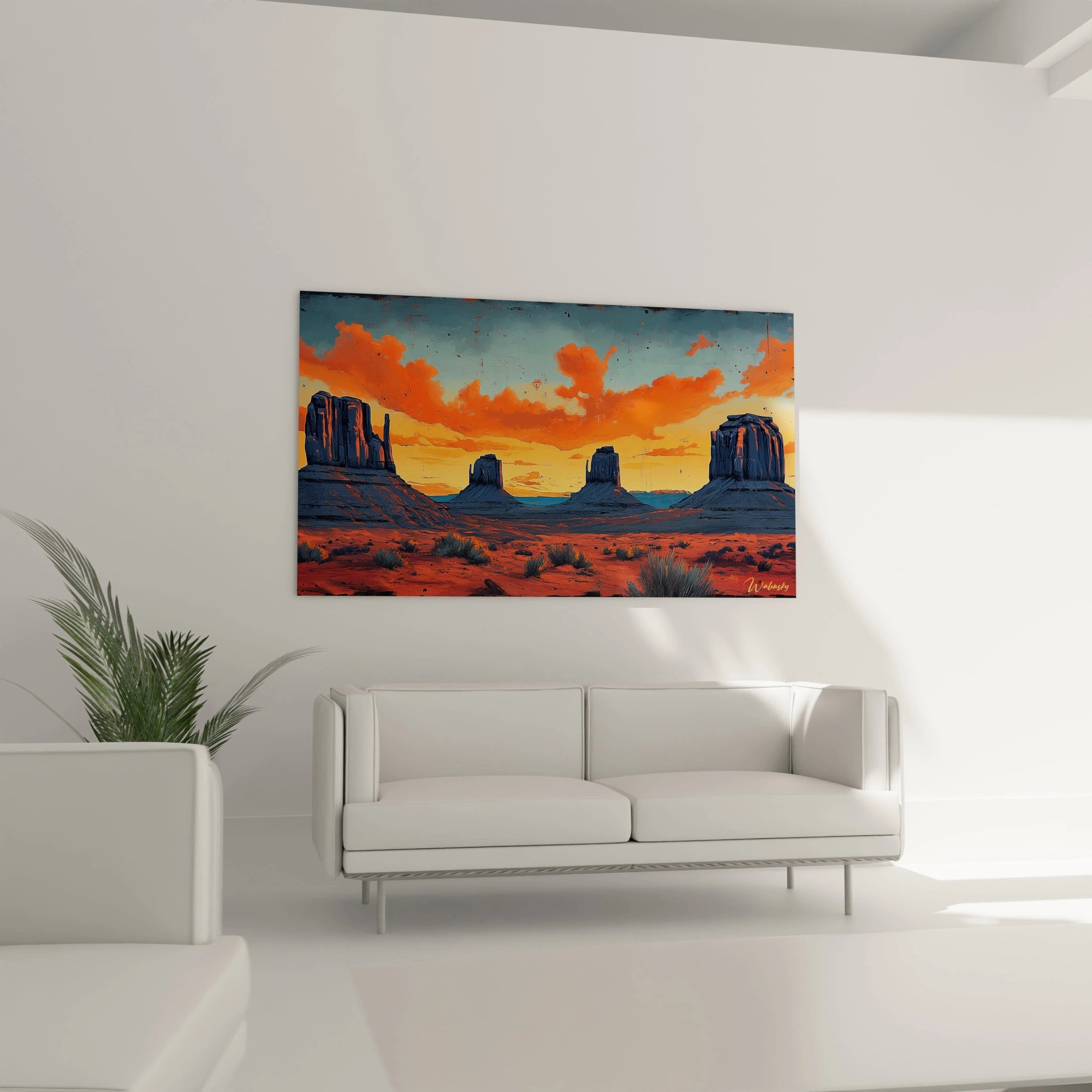 Vue panoramique d'un tableau désert montrant des mesas iconiques, un ciel orangé intense et des touches de végétation désertique sur fond de paysage aride.