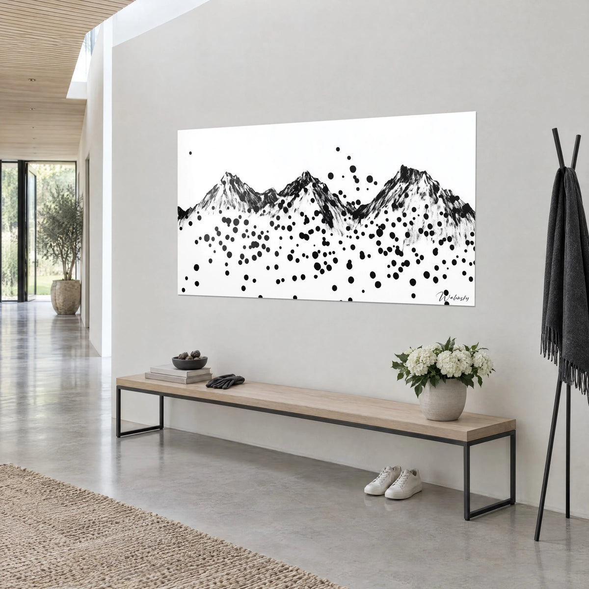 Wall art mountain range drawn in black charcoal, rain of dots on white paper, wooden bench and white flowers, three-quarter view