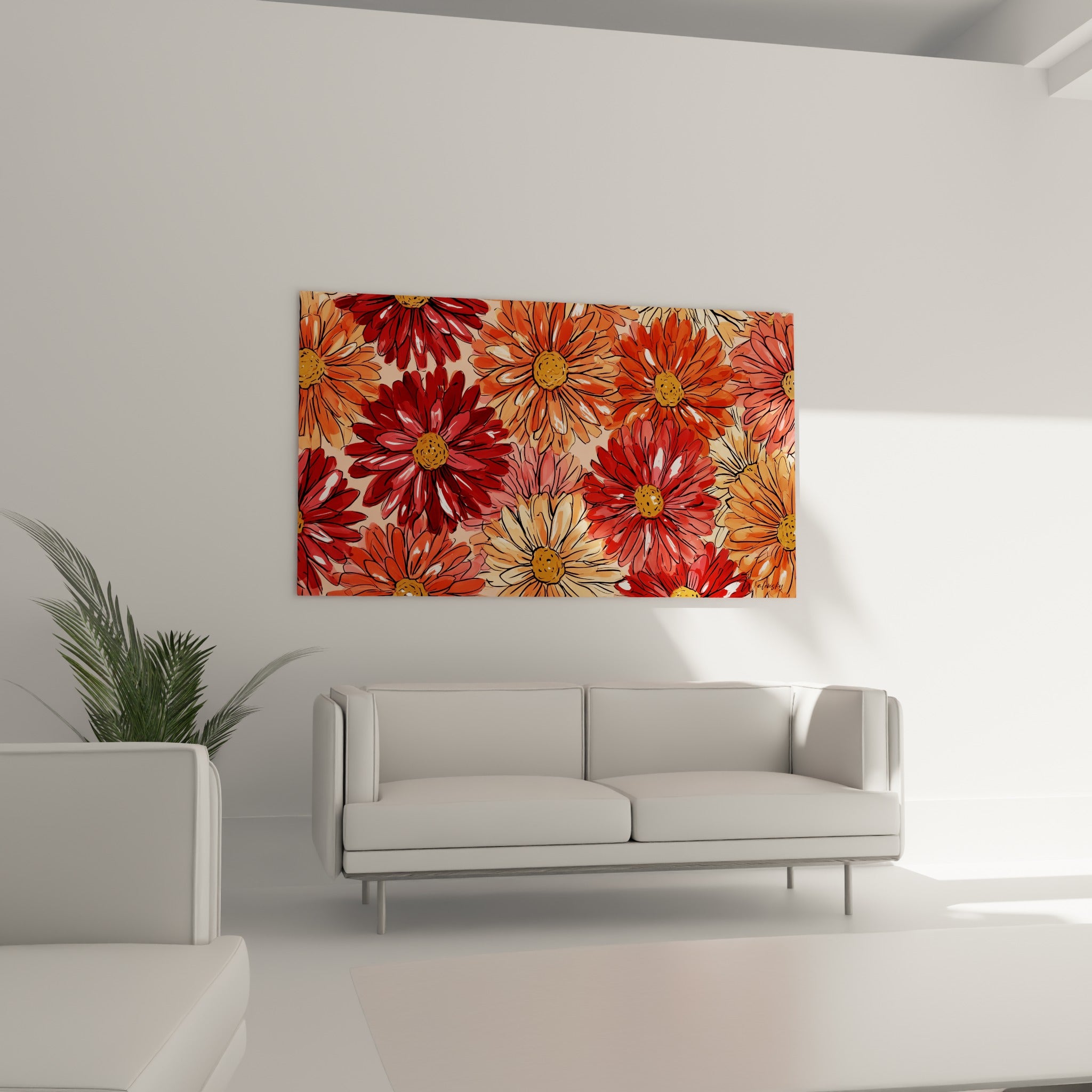 Fleurs de dahlia rouge vif et orangé accrochées au-dessus d'un canapé dans un salon lumineux