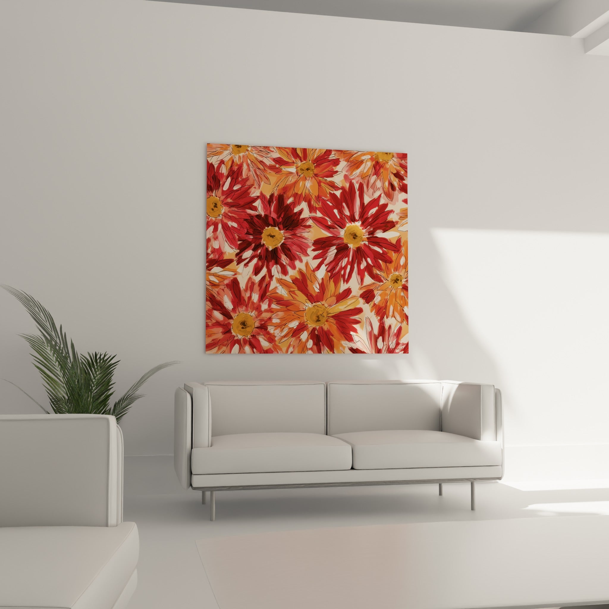 Fleurs de dahlia rouge profond et orange vif serrées entre elles, au-dessus d'un canapé dans un salon lumineux