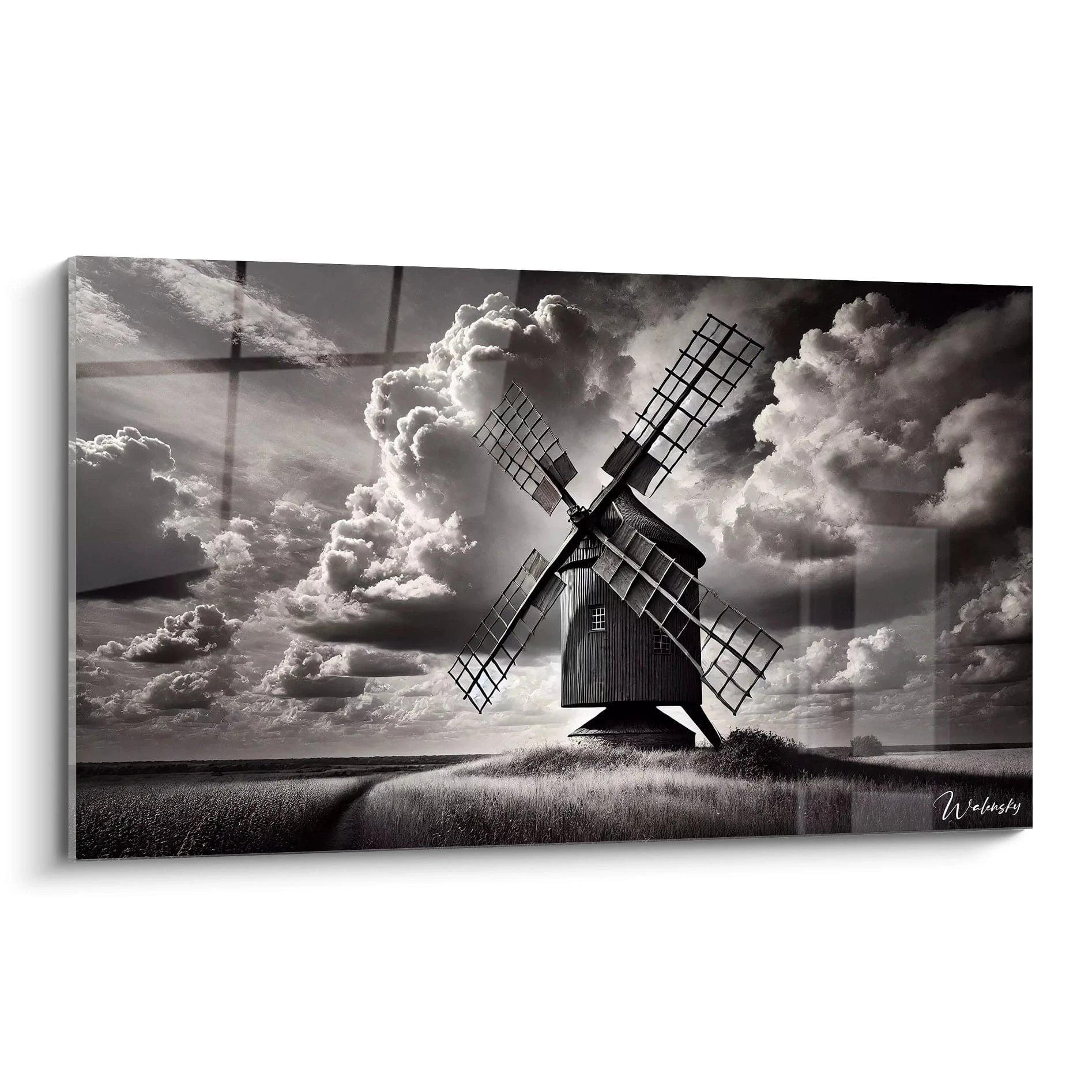 Tableau noir et blanc representant un moulin ancien sous un ciel tourmente vu de biais dans des nuances dramatiques de gris pour un effet intemporel et poetique.