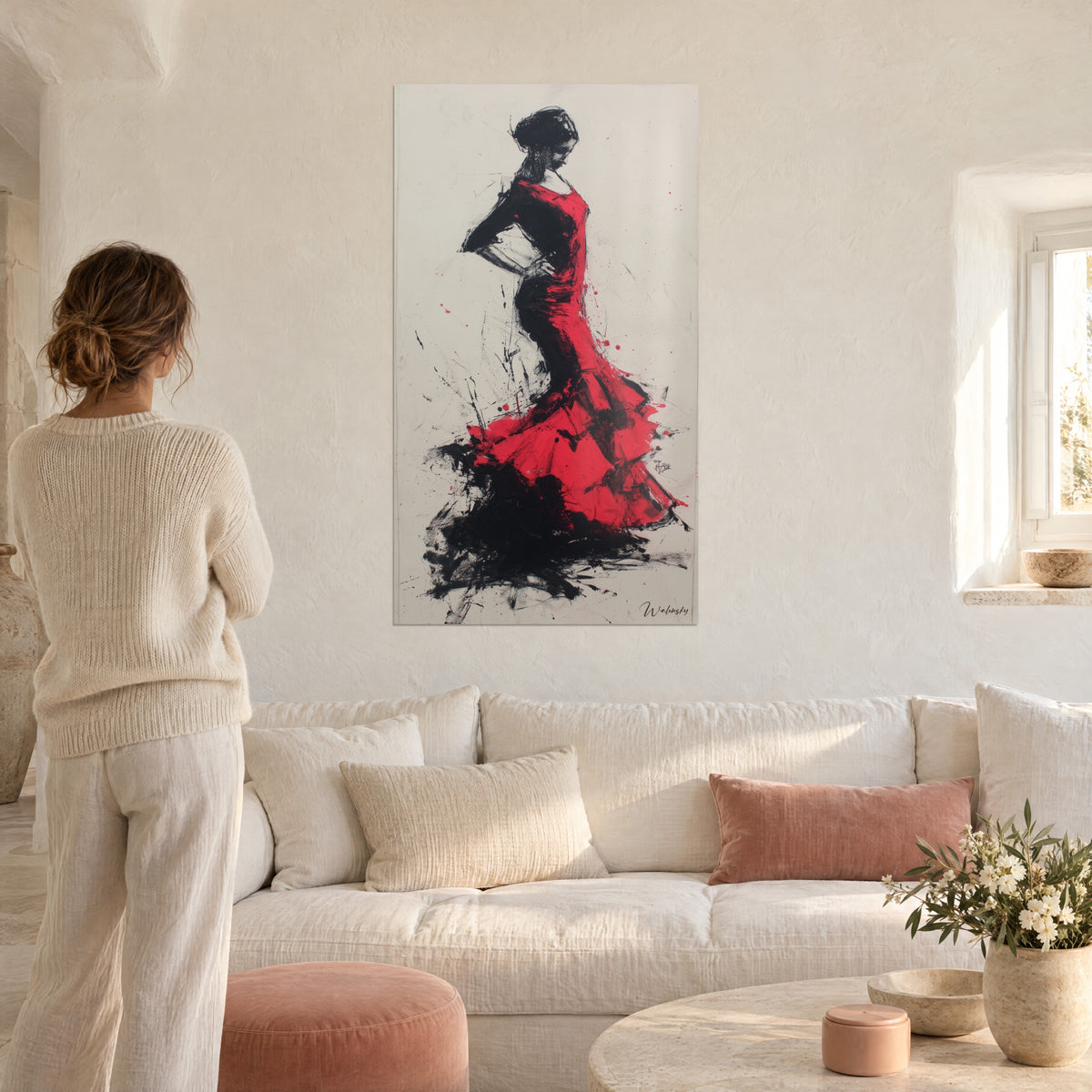 Wall art flamenco dancer in bright red and black ruffled dress, ink splashes across the flounces, woman seen from behind, above a sofa in a bright living room