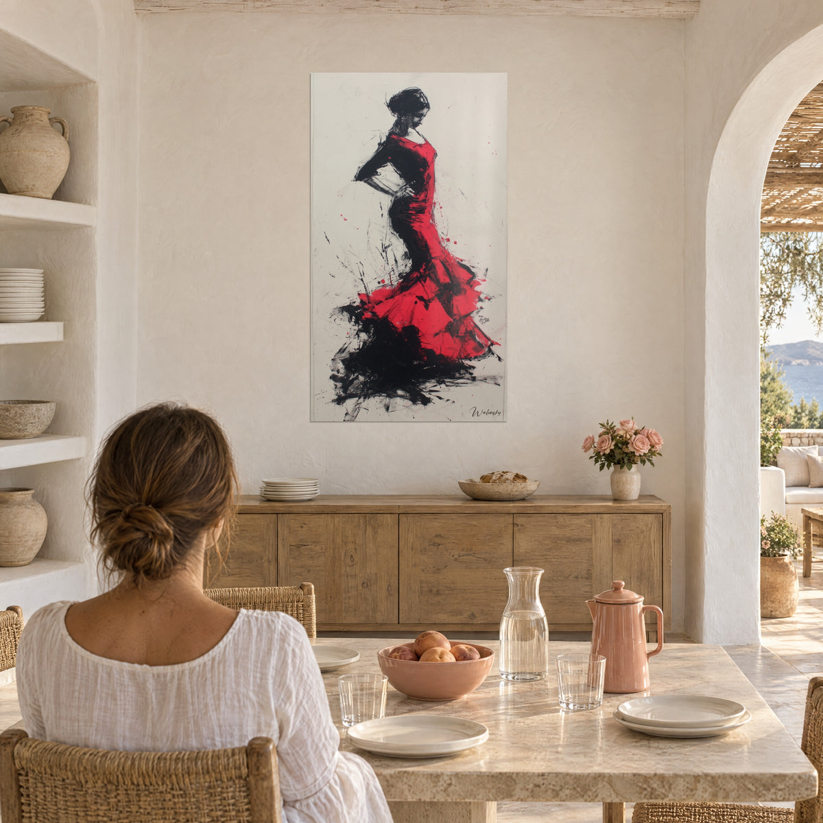 Wall art bailaora in blood-red petticoats with black ink splatters on light paper, facing a dining table, a woman seen from behind near an archway