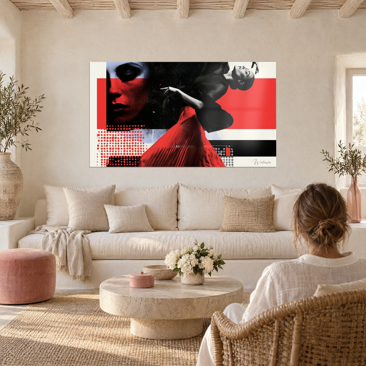 Wall art dancer in bright red pleated skirt, arched black torso on white background, above a sofa in a bright living room