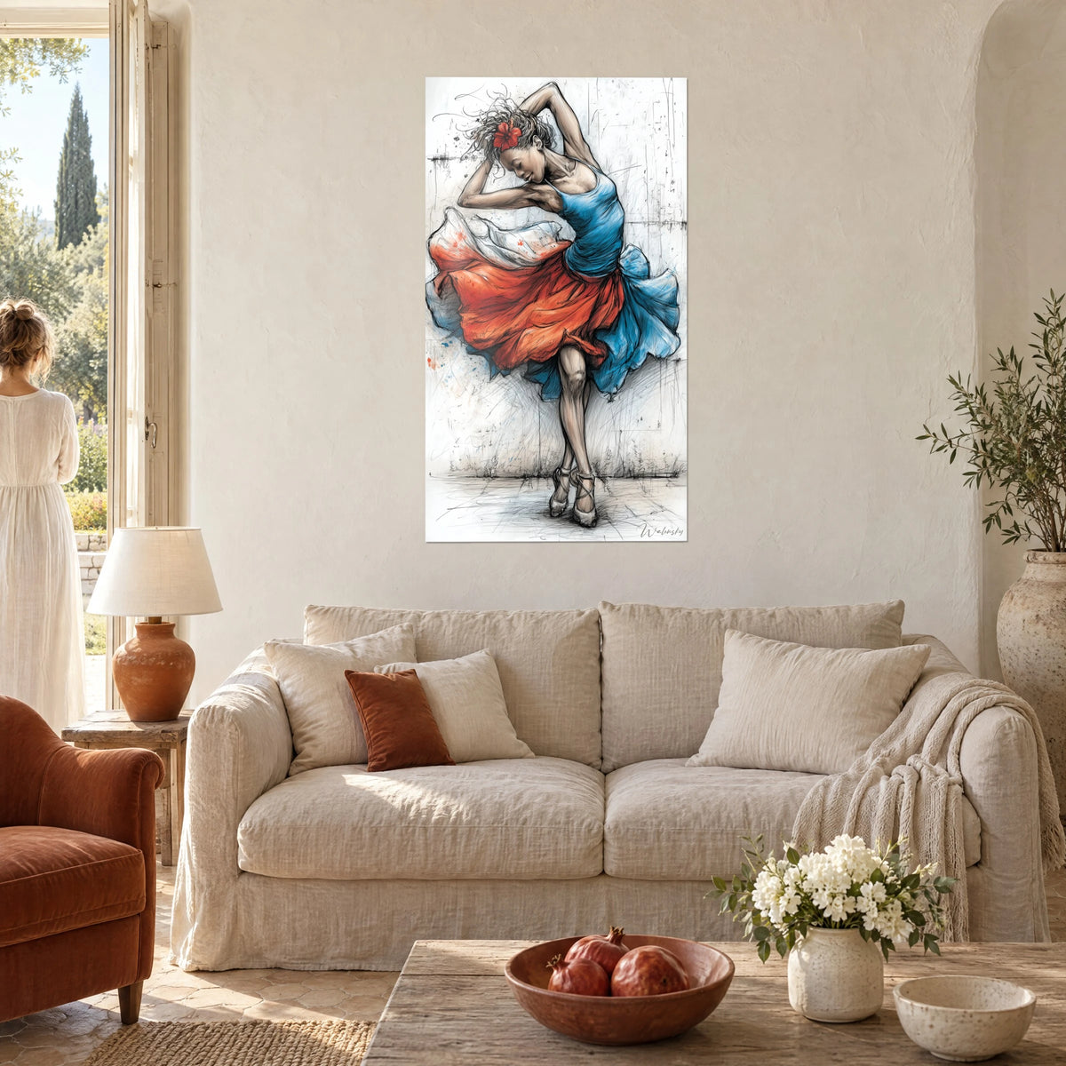 Wall art flamenco dancer with a red flower in her hair, orange and blue skirt swirling, above a sofa in a bright living room