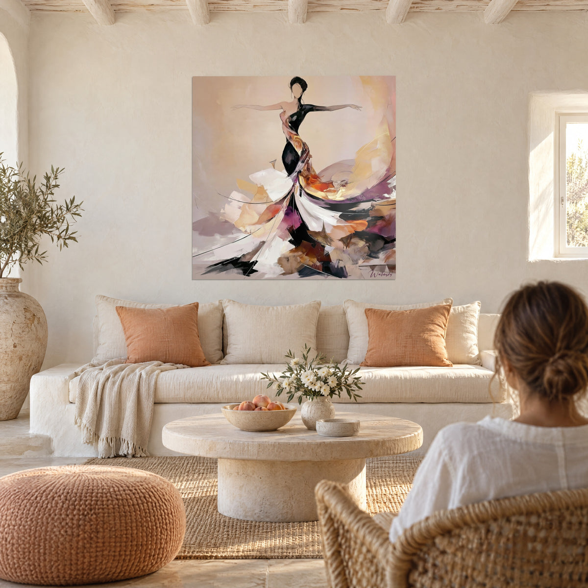 Tableau danseuse aux bras ouverts, robe noire et blanche en coups de spatule orange et mauve, au-dessus d'un canapé dans un salon lumineux
