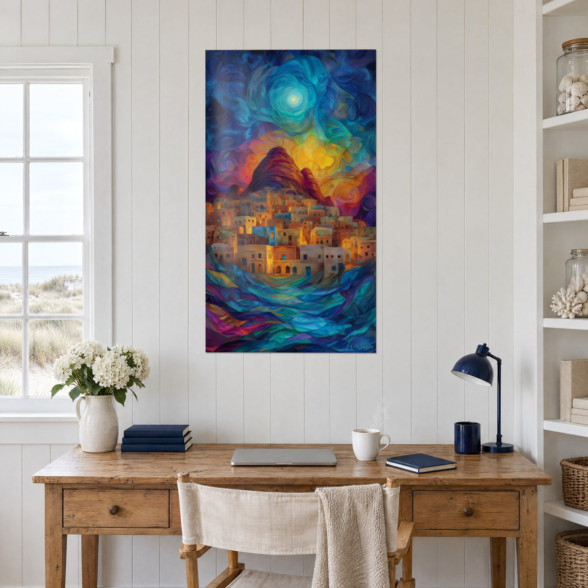 Wall art of a desert city with saffron walls, dark red peak and swirls of blue night, above a wooden desk near a window