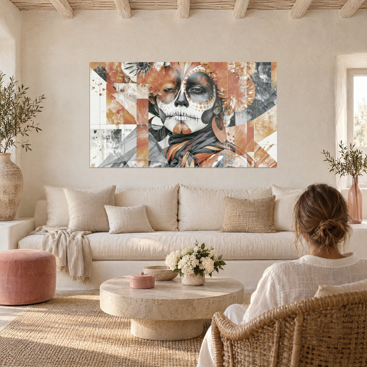 Wall art painted sugar skull, terracotta and grey, marigold crown, two people seen from behind above a sofa in a bright living room