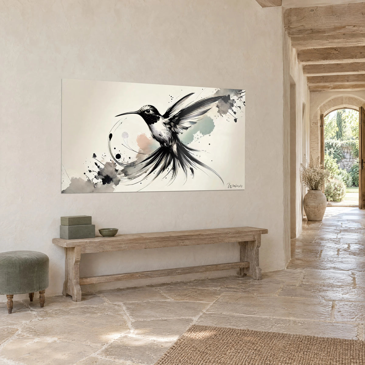 Wall art of a hummingbird with a long, slender beak, grey splashes and sage green accents, hung in a corridor with golden stone walls