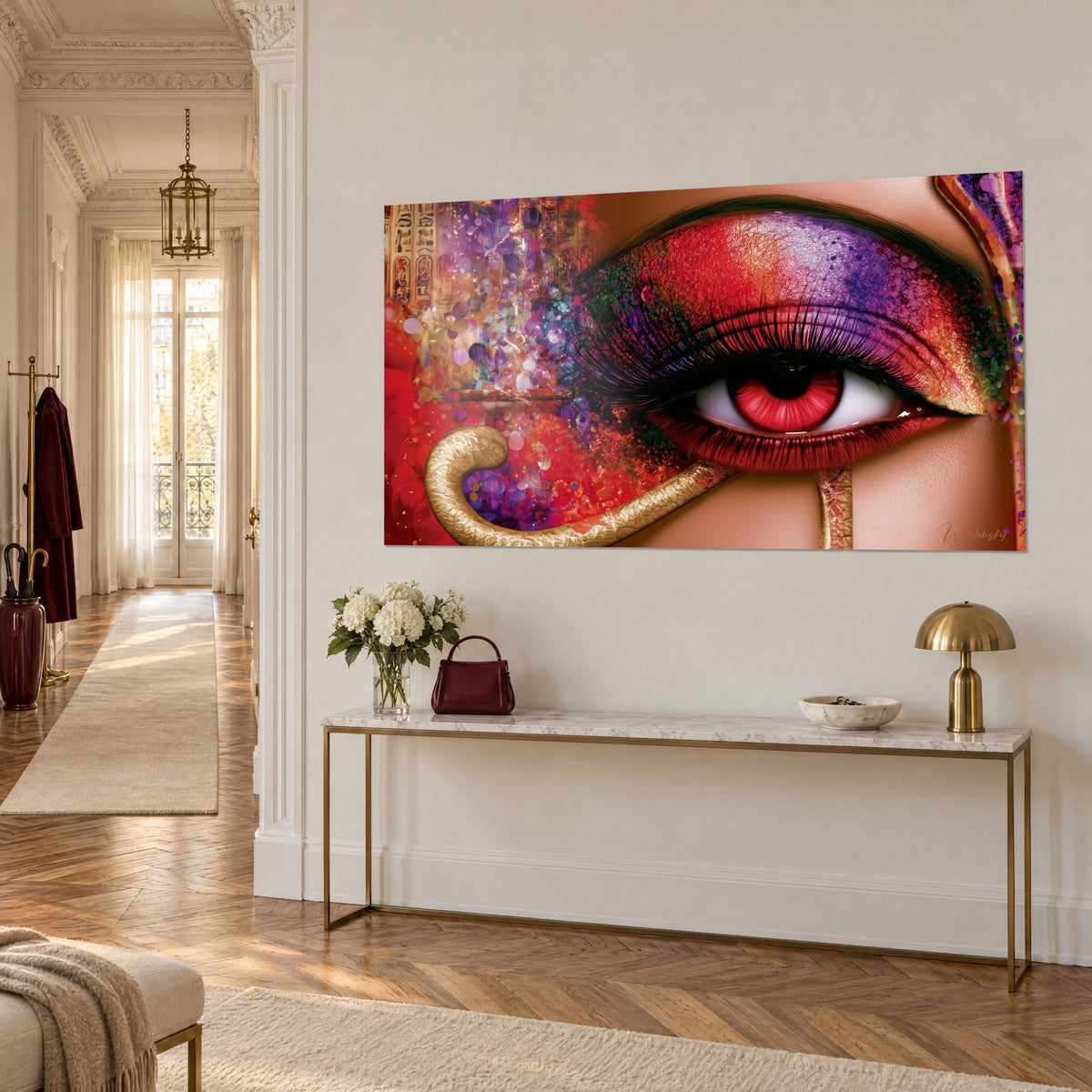 Wall art Egyptian gaze made up with red and violet glitter, gold hieroglyphs on the left, on a brass console, three-quarter view