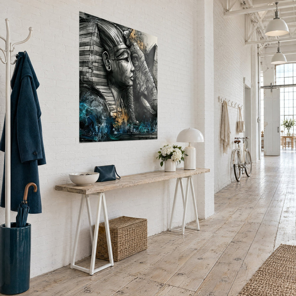 Wall art Egyptian royal mask in profile against an elephant, black and silvery grey, ochre touches, hung beside a wooden console